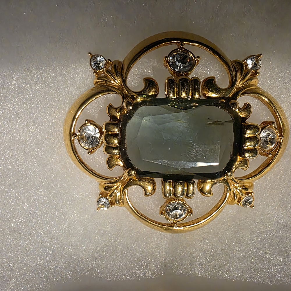 Vintage Nolan Miller Gold Toned Rhinestone Green Brooch with Crystal Accents.